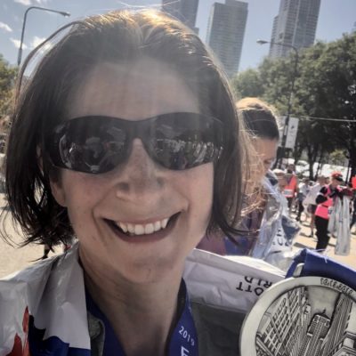 Rachel Spaulding holding a medal at the Chicago Marathon.